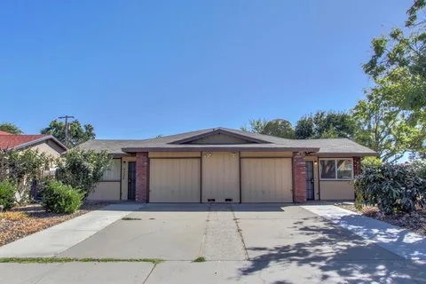 Multi-family duplex with paired garage doors